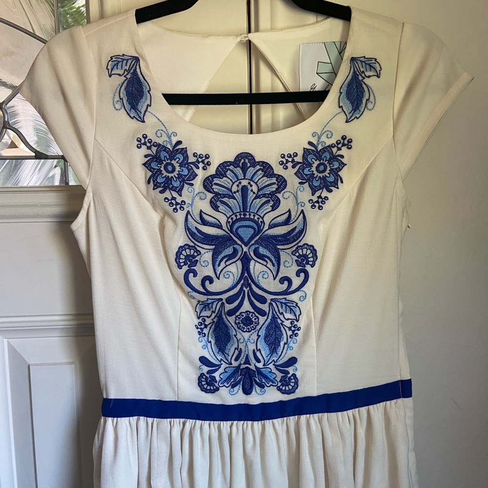 Long cream wedding dress with blue flowers